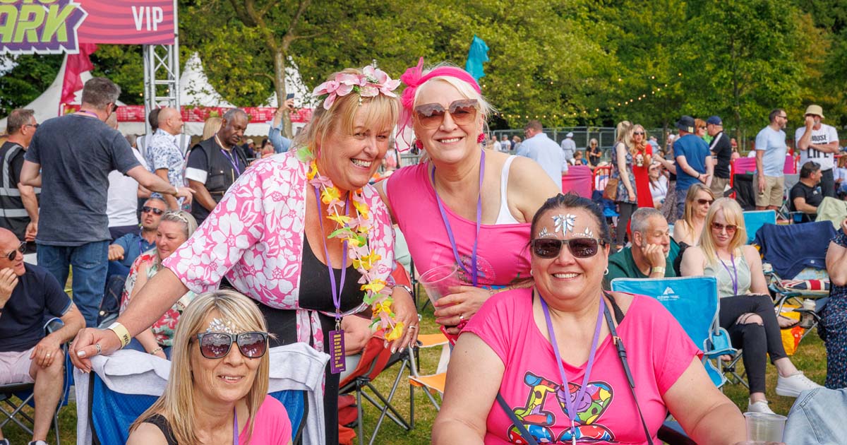 Group of women in pink at Music in the Park, Leyland
